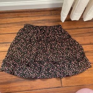 Black skirt with roses on is XS